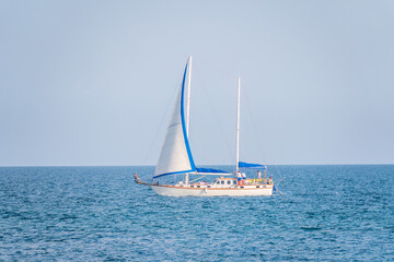 Obraz premium Sailing yacht in the blue calm sea.