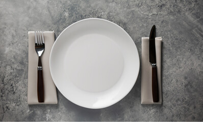 White plate, cutlery on stone table, Table setting, flat lay image