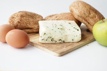  cheese, apple, eggs, brown bread on table 