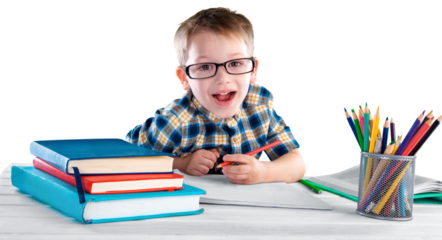 Happy child writing in a notebook in the classroom