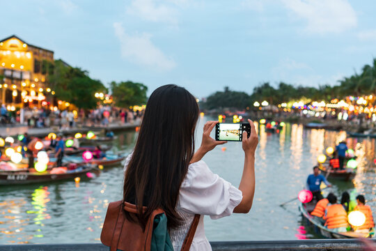 Happy Asian tourist woman enjoy sightseeing in Hoi An old town Vietnam. Copy space