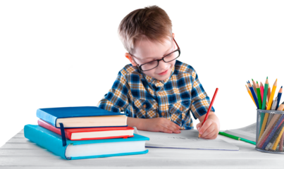 Happy child writing in a notebook in the classroom