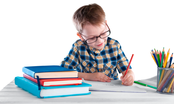 Happy child writing in a notebook in the classroom