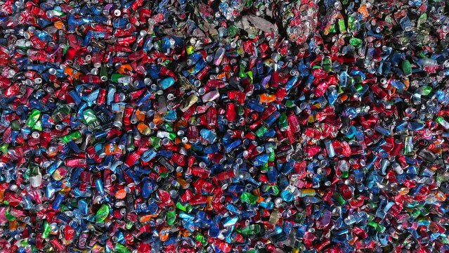 Soda cans heap in a recycling plant in various colors, Aluminum recycling plant
