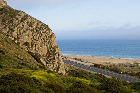 Ascending the difficult Chumash Trail offers views from high above the Pacific Coast Highway on one side to a vantage point over the Santa Monica Mountains, through steep paths lined by flowers