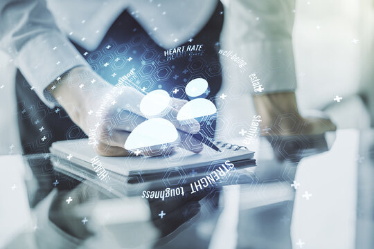 Creative abstract people icons hologram and man hand writing in diary on background, life and health insurance concept. Multi exposure