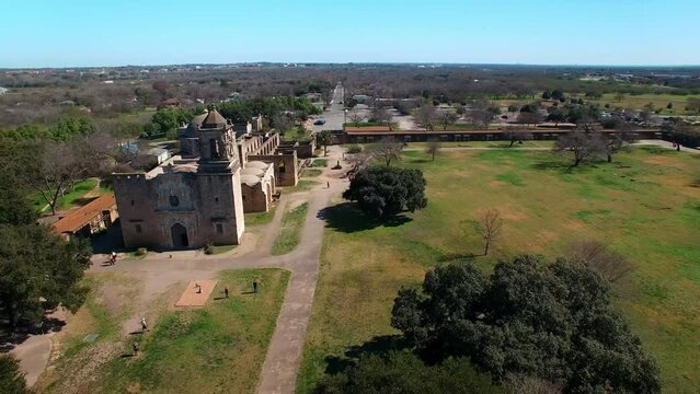 Aerial Panning Shot Of Mission San Jose Church Against Blue Sky, Drone Flying Over City On Sunny Day - San Antonio, Texas