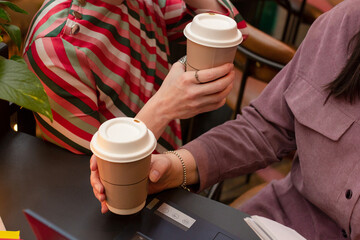 Two women drinking coffee together in cafe, colleagues meeting, friends on lunch