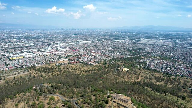 drone shot of east Mexico city over cerro de la estrella and central de abastos in iztapalapa
