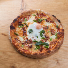 pizza with salami and cheese on wooden table