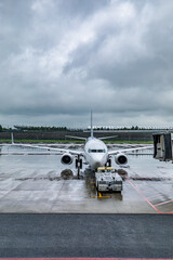 Airplanes being parked at the airport on a rainy day