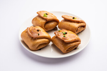 Lavang Latika: traditional Indian sweet. Crescent shape, deep-fried, soaked in sugar syrup. Served during festivals.