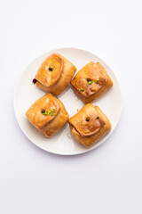 Lavang Latika: traditional Indian sweet. Crescent shape, deep-fried, soaked in sugar syrup. Served during festivals.