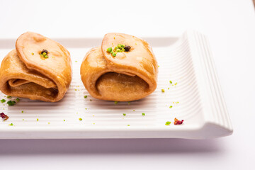 Lavang Latika: traditional Indian sweet. Crescent shape, deep-fried, soaked in sugar syrup. Served during festivals.