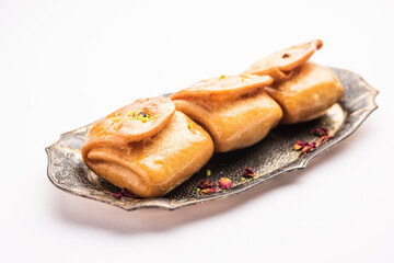 Lavang Latika: traditional Indian sweet. Crescent shape, deep-fried, soaked in sugar syrup. Served during festivals.