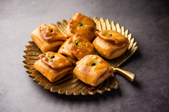 Lavang Latika: traditional Indian sweet. Crescent shape, deep-fried, soaked in sugar syrup. Served during festivals.
