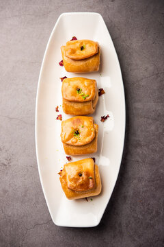 Lavang Latika: traditional Indian sweet. Crescent shape, deep-fried, soaked in sugar syrup. Served during festivals.