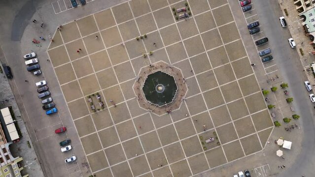 Fountain in the center of the historic market square. Beautiful aerial top view flight 
Budweis Budejovice old town in Czech Republic, summer of 2023. vertical bird's eye view drone
4K uhd footage.