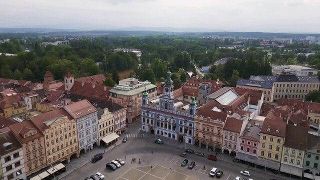 Colorful facade of City Hall at the historic market town square. Smooth aerial top view flight 
Budweis Budejovice old town in Czech Republic, summer of 2023. fly reverse drone
4K uhd footage.