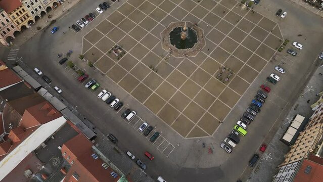 Fountain in the center of the historic market square Magic aerial top view flight 
Budweis Budejovice old town in Czech Republic, summer of 2023. tilt up drone
4K uhd footage.