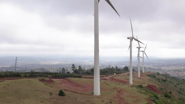 Drone vertical rise revealing Ngong hills, Kenya windmills