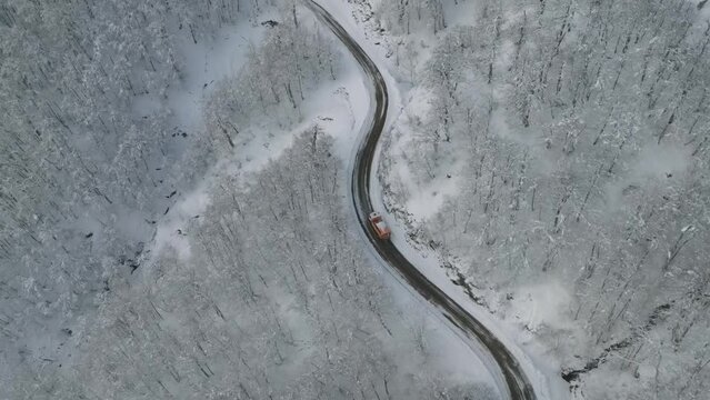 snowplow truck over road from aerial view