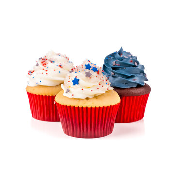 Independence Day or 4th of July Cup Cakes in red, white and blue colors of the American flag. Isolated on white background. Shallow field of view. Illustrative Generative Ai.