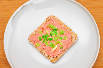 Rice Cake Sandwich with Fish Cream and Green Onions on White Plate. Easy Breakfast. Diet Food. Quick and Healthy Sandwiches. Crispbread with Tasty Filling. Healthy Dietary Snack