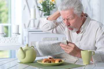 Senior man reading newspaper