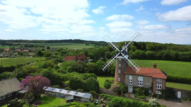 Wider aerial view of a windmill situated in the English countryside. Weybourne, Norfolk, UK.