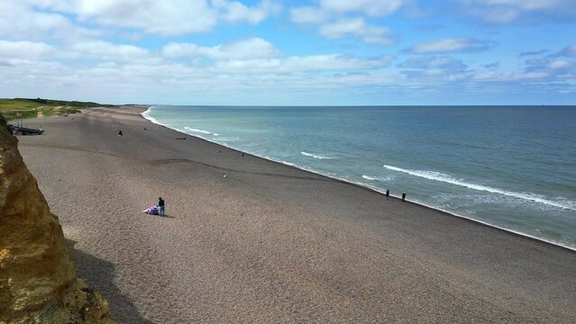 Aerial view of Weybourne Beach, Norfolk and the eroded cliffs. Weybourne, Norfolk, UK.