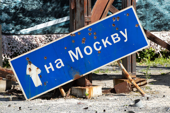 Broken road sign from bullets with an arrow and text to Moscow on the roads of Ukraine, stop the war in Ukraine, the way to Russia