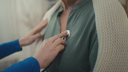 Close-up doctor hands examining senior patient with stethoscope, heart attack
