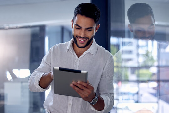 Tablet, night and research with a business man, happy while working alone in his office after hours. Technology, internet and smile with a male employee doing an online search for information or data