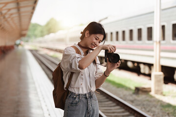 Asian Tourist person backpacker to travel at train station. Tourism and travel in the summer
