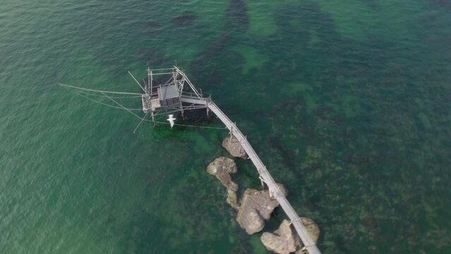 Impressive fishing platforms on stilts on the trabocchi coast of Abruzzo, Punta Aderci, Italy 4k drone