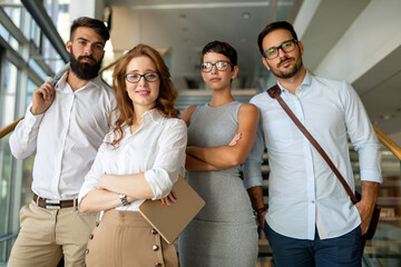Group of young business people working and communicating at the office