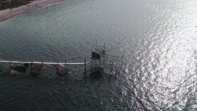 Impressive fishing platforms on stilts on the trabocchi coast of Abruzzo, Punta Aderci, Italy 4k drone