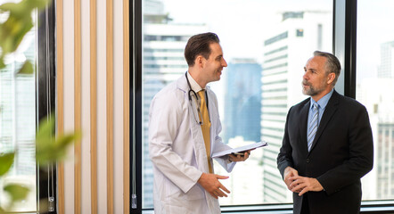 Man doctor wearing uniform with stethoscope service help support discussing and consulting talk to sick senior man patient about checkup result information in hospital.healthcare and medicine