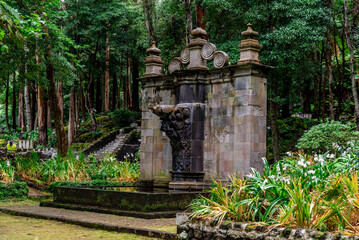 Sculptural stone fountain in the Recreation Area of the Mata da Serreta Forest Reserve in Terceira Island, Azores, Portugal. Benches