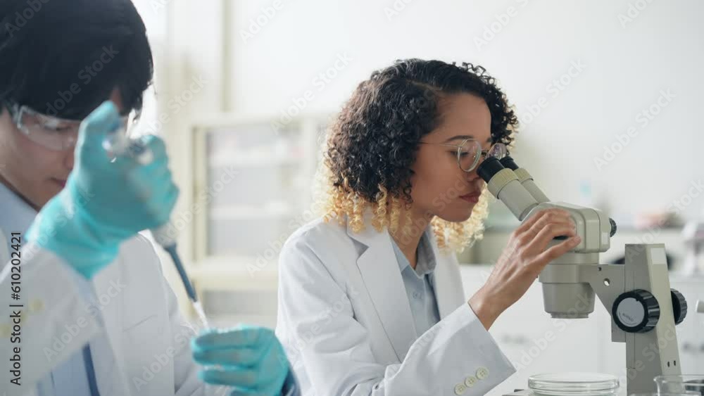 Poster multinational researcher group experimenting in the lab.