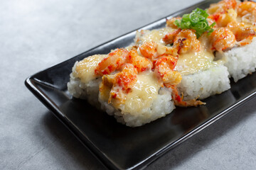 A closeup view of a plate of baked lobster roll.
