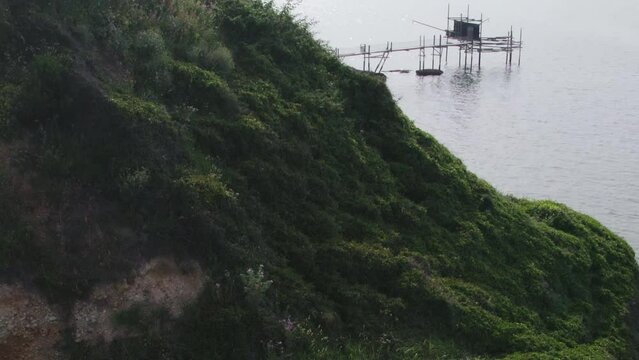 Impressive fishing platforms on stilts on the trabocchi coast of Abruzzo, Punta Aderci, Italy 4k drone