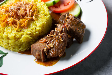 A closeup view of a plate of beef rendang.