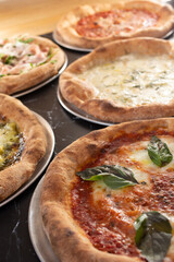 A view of several artisan pizzas.