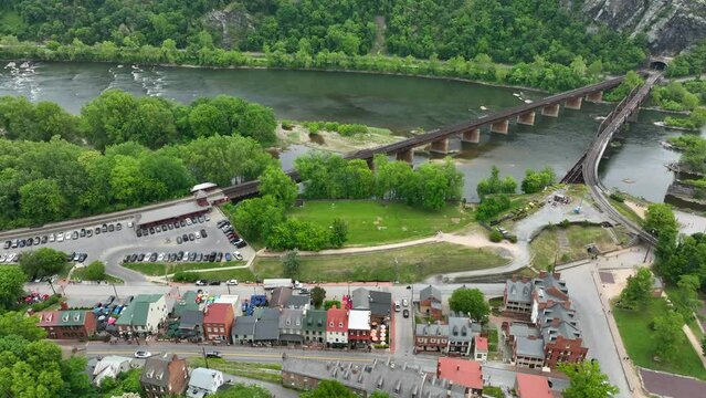 Railroad bridges with Shenandoah and Potomac Rivers. Historic buildings and railroad station. Aerial truck shot.