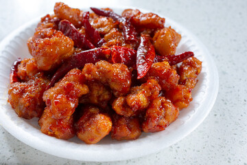 A view of a plate of spicy orange chicken.