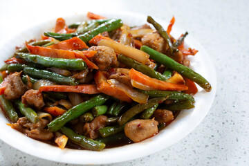 A view of a plate of green bean chicken.