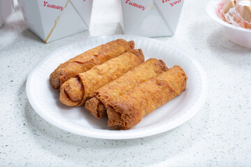 A view of a plate of egg rolls.