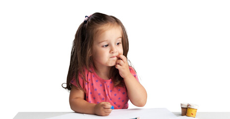 Cute little girl doing homework,writing and painting.